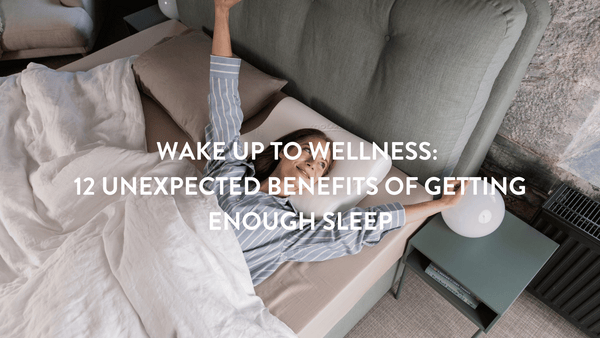 Person in light blue pyjamas waking up in bed with teal headboard in a stone walled cottage