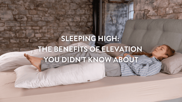 Sleep High Person lying on bed with their legs elevated on a Putnams bed wedge
