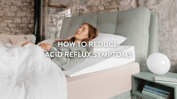 person lying in bed sleeping using a Putnams bed wedge to reduce acid reflux