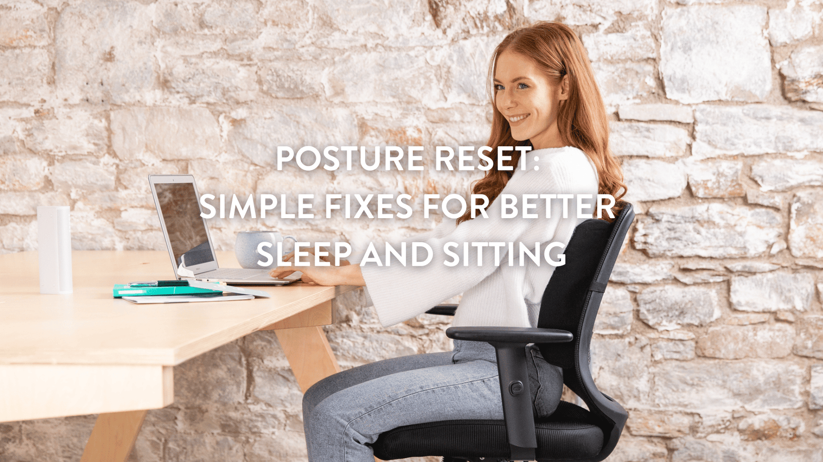 Woman sitting with good posture at a desk, working on a laptop, demonstrating ergonomic sitting for better posture and sleep.