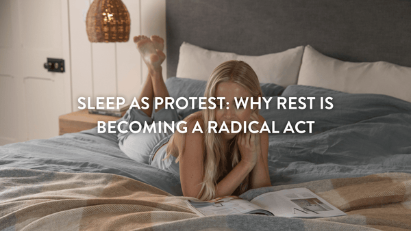 Person lying on top of a duvet reading a magazine relaxing