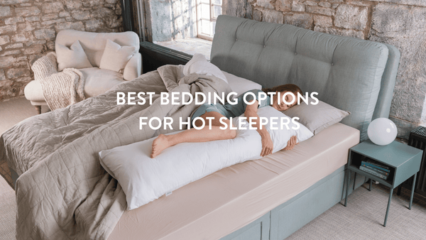 Person sleeping in a bed with a long Putnams body pillow 