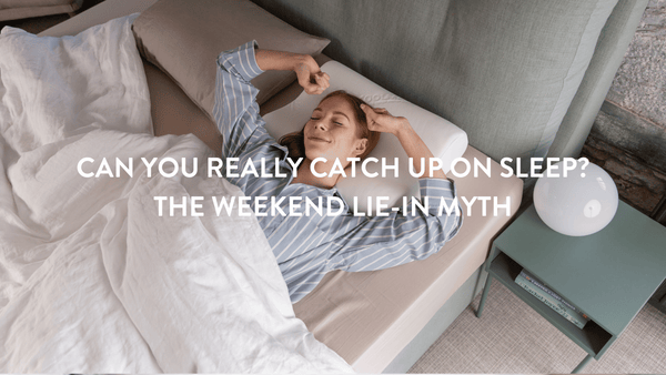 person waking up in bed from a good night's sleep 