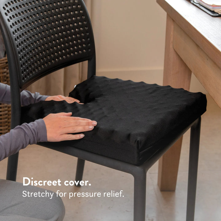 Tailbone Pain Cushion with a cut out for pressure relief at the back of the cushion. Stretch navy blue or black cover available in different sizes. High density foam with a 2 year guarantee.